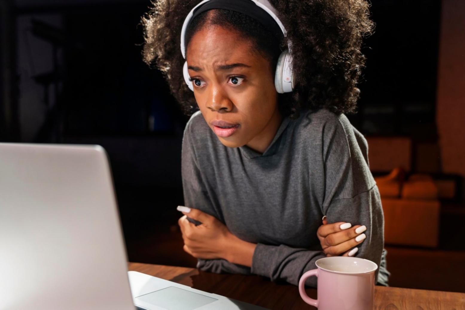 Student reviewing financial documents with notes spread across desk